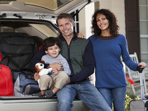 African American man and woman. Man is holding up keys to a new car.