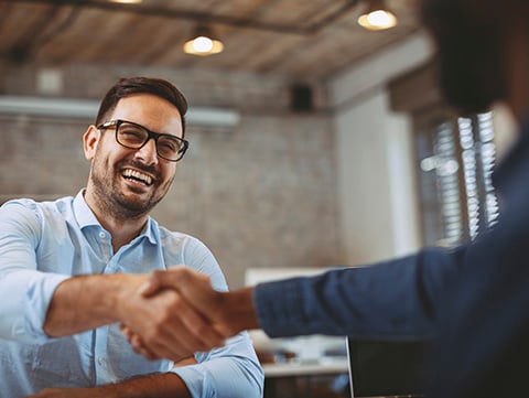 Man shaking hands with another person