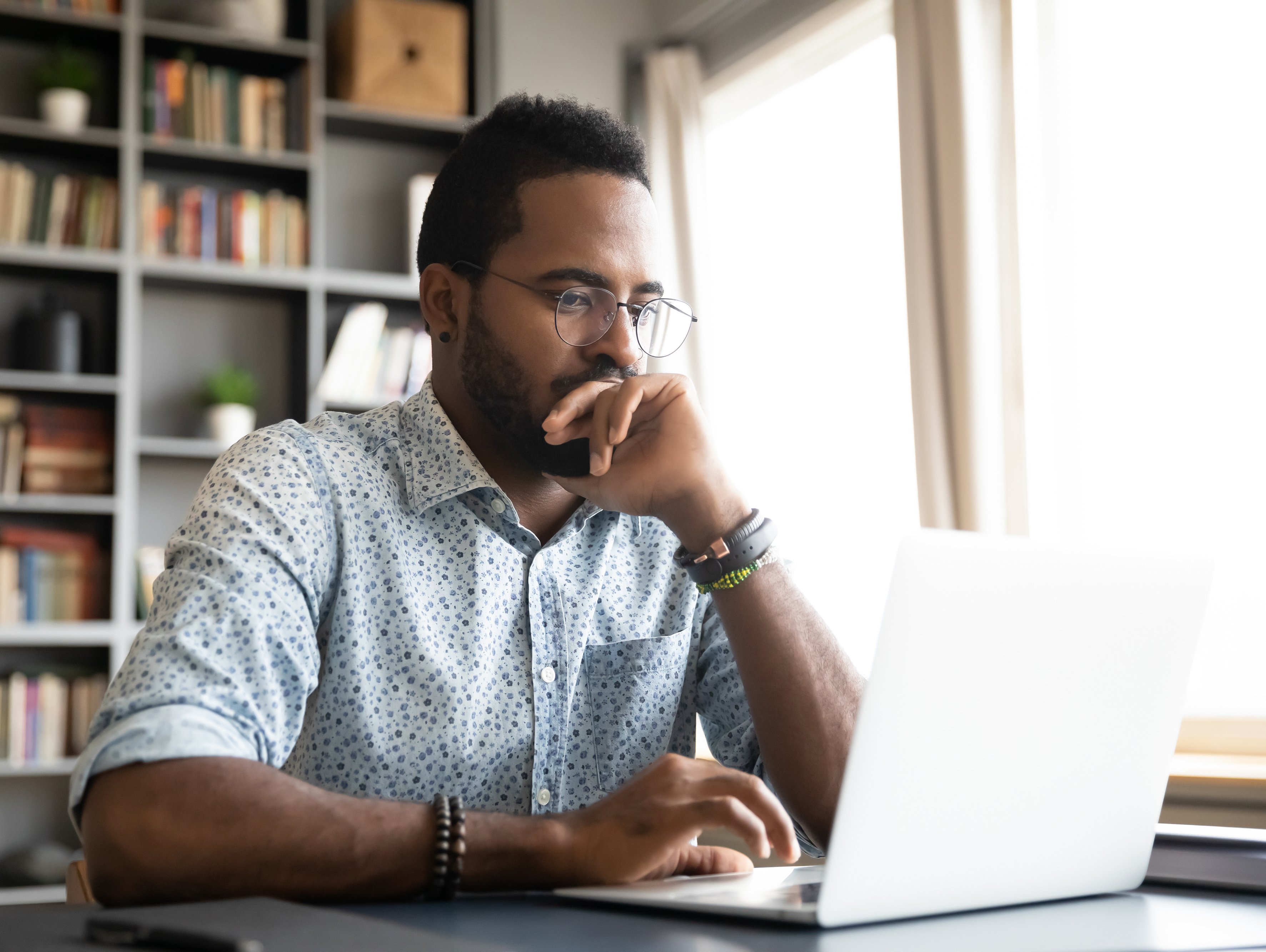 African-American man working at laptop